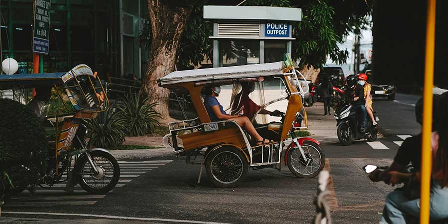 A Person Riding Brown Tricycle in the Philippines